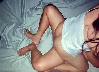 curious chubby asian pregnant mom rests in bedroom after intimate session