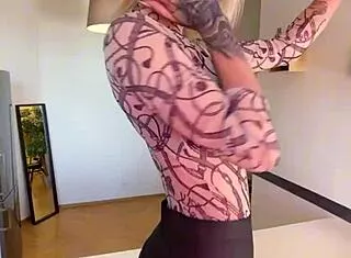 sophie van loo sizzles in grey leggings and heels on kitchen counter.