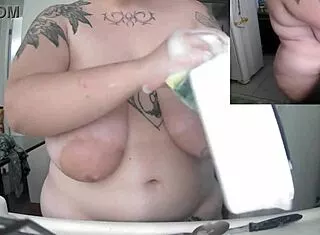 Naked Latina washes dishes with huge saggy tits swinging