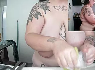 Naked Latina washes dishes with huge saggy tits swinging