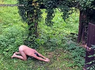 Dominatrix Mistress April Chains Slave For Garden Workout Enema Bondage