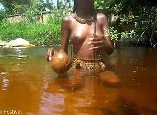 skinny tribe slut bares tits outdoors at beach