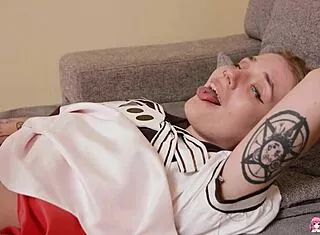 Sexy tattooed Angelina rubs shaved pussy to orgasm on couch