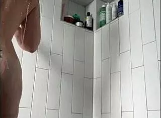 Pretty tattooed milf fingers wet clit and natural tits in steamy shower