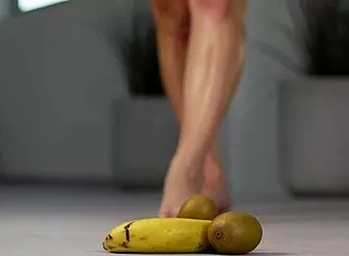 petite brunette crushes fruits under high heels in steamy foot fetish tease