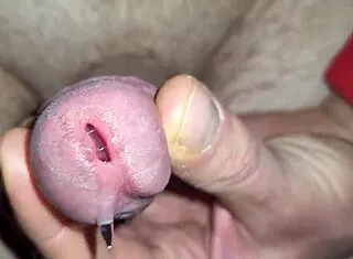 shimmering precum drips before thick ropes of cum explode close-up