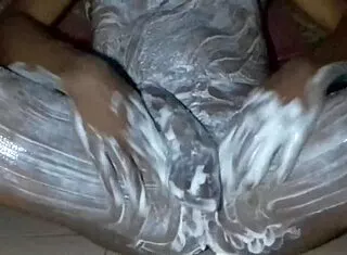 african dude slathers lotion over monster black cock and fat ass solo in bedroom stroking hard