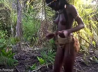 perfect body dark skin african village girl dancing in raffia half naked outdoor
