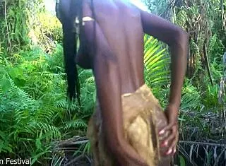 perfect body dark skin african village girl dancing in raffia half naked outdoor