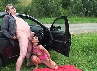 Old grandpa takes his granddaughter for a ride in the car