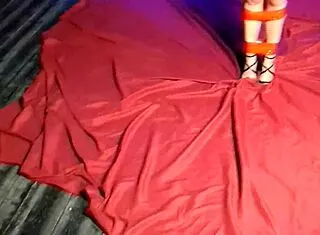 A girl tied up with red duct tape and gagging during a photo shoot
