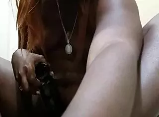 Naejae rides her biggest black dildo hard and squirts all over it