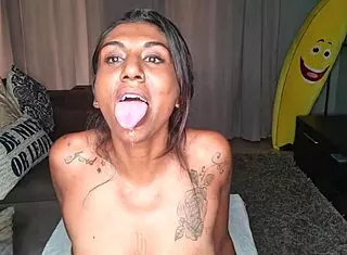 Desi wiggles tongue on sofa