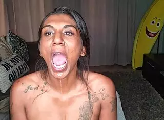 Desi wiggles tongue on sofa