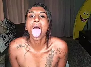 Desi wiggles tongue on sofa