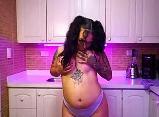 Abril Jones undresses in kitchen