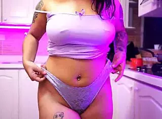 Abril Jones undresses in kitchen