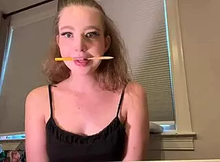 Contestant challenges to hold pencils with tongue in spitting game