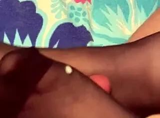 A milf gives a footjob in her black reinforced toe stockings.