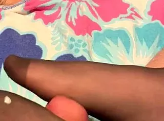 A milf gives a footjob in her black reinforced toe stockings.