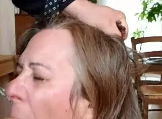 female slave performs blowjob in submission