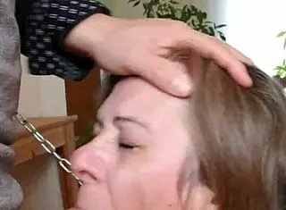 female slave performs blowjob in submission