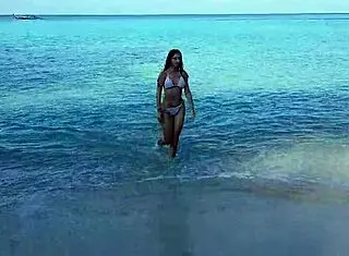 Naked redhead bathes on public beach.