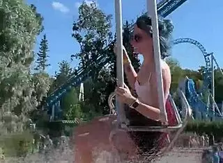 Teen enjoys a thrilling ride on the ferris wheel in public