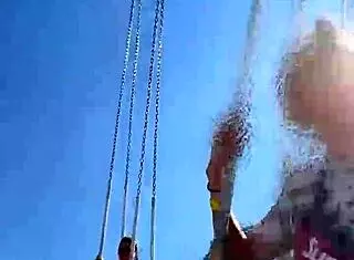 Teen enjoys a thrilling ride on the ferris wheel in public