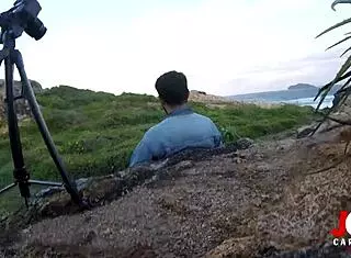 young girl giving blowjob on rocks by the sea