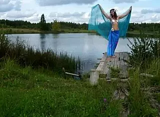 Mature lady poses in bikini on lake