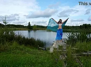 Mature lady poses in bikini on lake