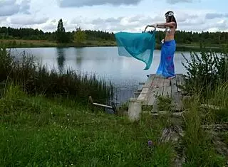 Mature lady poses in bikini on lake