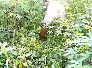 King's ebony maid gets fucked by two guys outdoors on the cassava farm