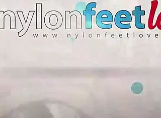 redhead in pantyhose teases feet outdoors