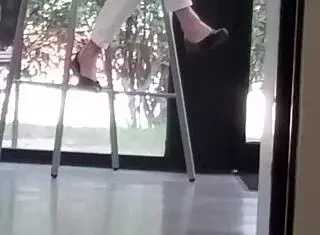 Mature woman playfully engages with shoes