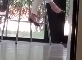 Mature woman playfully engages with shoes