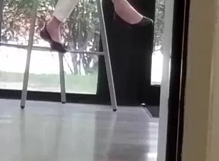 Mature woman playfully engages with shoes