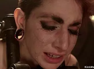 This tattooed redhead gets hard whipped and bound in a bizarre bondage session with toys and gagging