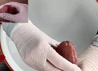 Patient POV: White latex gloves give close-up handjob on glans in medical water features