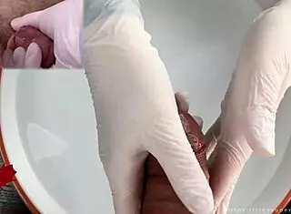 Patient POV: White latex gloves give close-up handjob on glans in medical water features