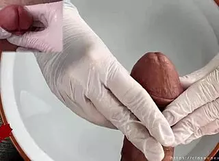 Patient POV: White latex gloves give close-up handjob on glans in medical water features