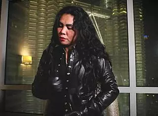 Asian dominatrix performs leather fetish domination.