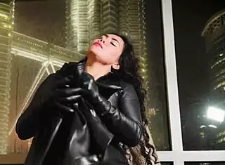 Asian dominatrix performs leather fetish domination.