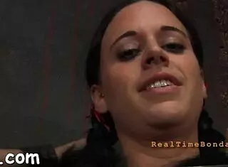 Gal performs striptease inside the cage, clothes ripping