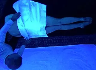 Teen Gigi Breeze enjoys blacklight massage sensually
