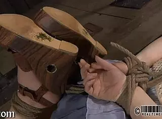 The femdom mistress dominates her submissive in sadomasochistic play