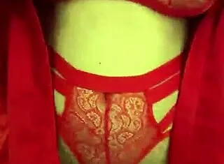 brunette in red lingerie touching her big tits