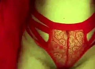 brunette in red lingerie touching her big tits