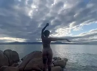 Bold shibari bondage exposes small tits in public outdoor setting